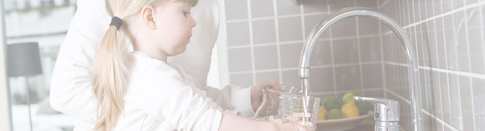 Child Filling Water Jug